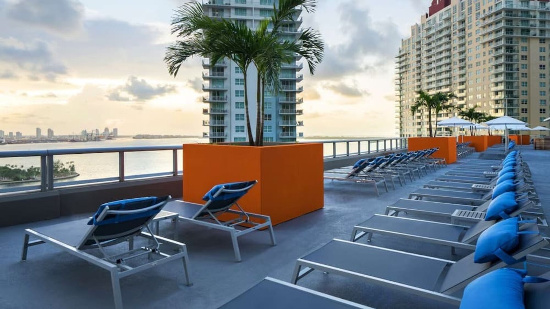 Rooftop terrace with lounge seating and beatiful seaside view at Hyatt Centric Brickell Miami.