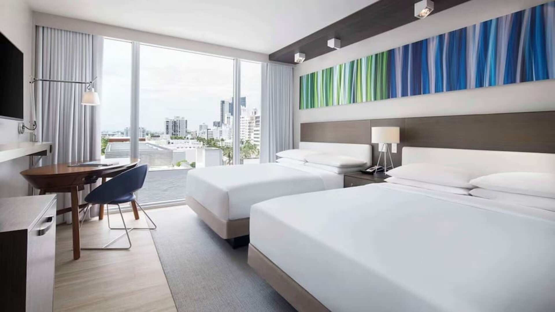 Day use twin room with floor to ceiling windows, work desk and private bathroom at Hyatt Centric Miami South Beach.