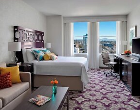 Day use room with TV, work desk, sofa and natural light at Courtyard San Diego Downtown.