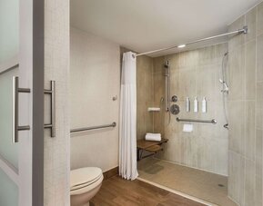 Private guest bathroom with shower and free toiletries at Embassy Suites By Hilton Miami - International Airport.