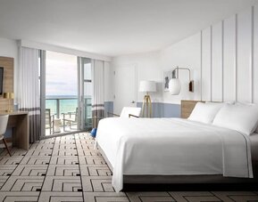 Day use room with king bed, work desk, balcony and private bathroom at Cadillac Hotel & Beach Club, Autograph Collection.