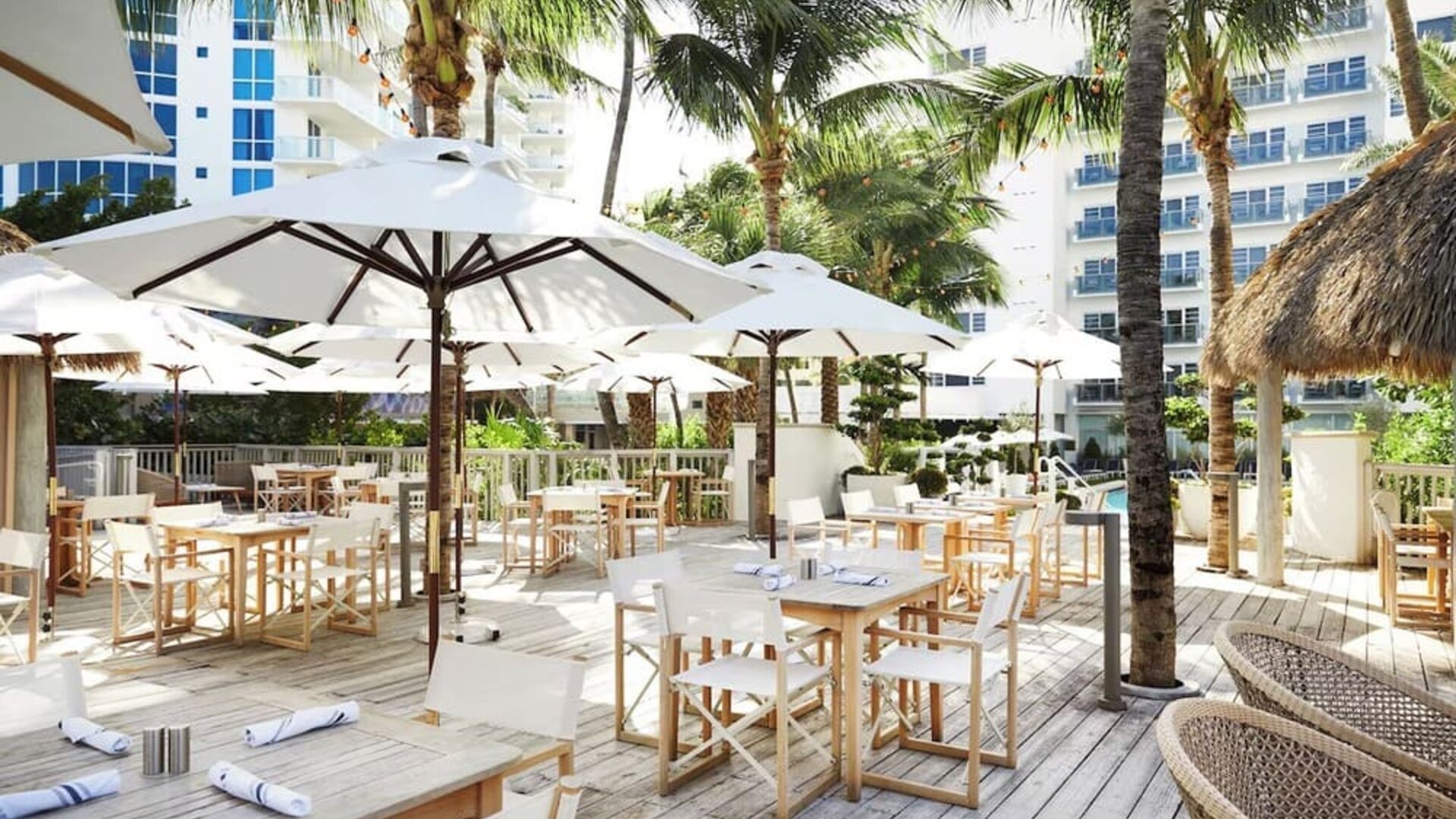 Outdoor lounge and dining area with comfortable seating at Cadillac Hotel & Beach Club, Autograph Collection.