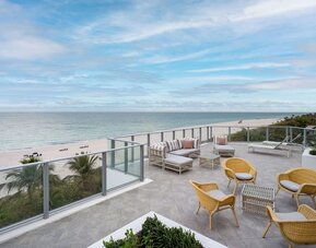 Terrace lounge seating with beautiful view at Cadillac Hotel & Beach Club, Autograph Collection.