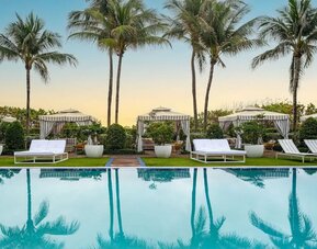 Outdoor pool with lounge seating at Cadillac Hotel & Beach Club, Autograph Collection.