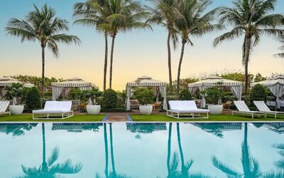 Outdoor pool with lounge seating at Cadillac Hotel & Beach Club, Autograph Collection.