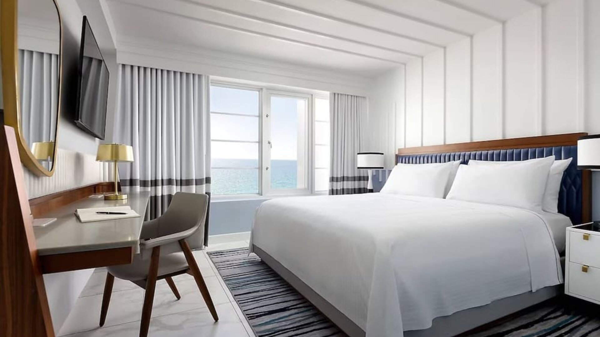 Day use room with king bed, large windows, work desk and private bathroom at Cadillac Hotel & Beach Club, Autograph Collection.
