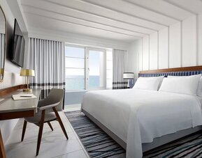 Day use room with king bed, large windows, work desk and private bathroom at Cadillac Hotel & Beach Club, Autograph Collection.