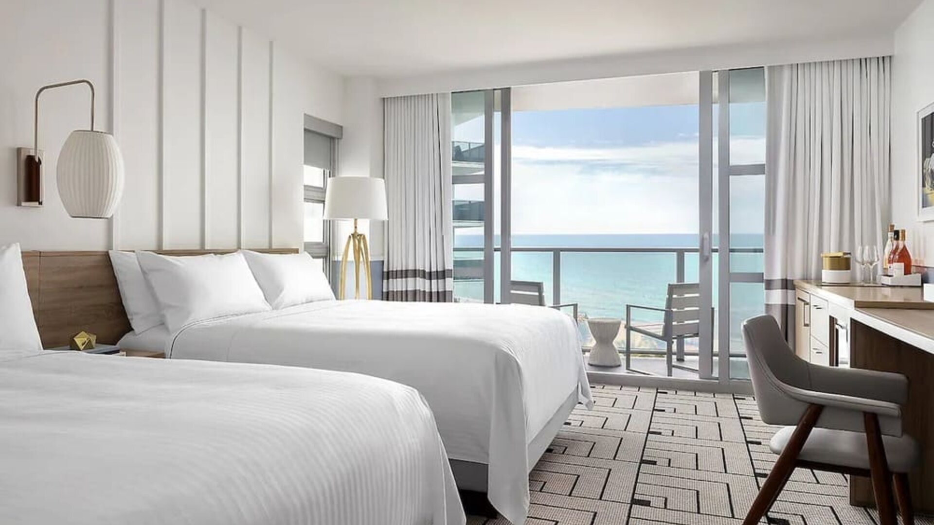 Day use twin room with work desk, balcony and private guest bathroom at Cadillac Hotel & Beach Club, Autograph Collection.