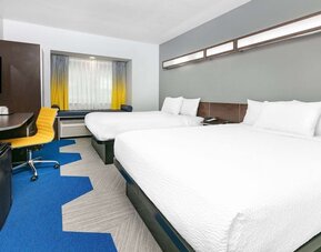 Day use room with TV and work desk at Microtel Inn And Suites By Wyndham Austin Airport.