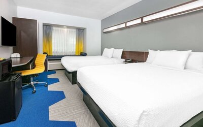 Day use room with TV and work desk at Microtel Inn And Suites By Wyndham Austin Airport.