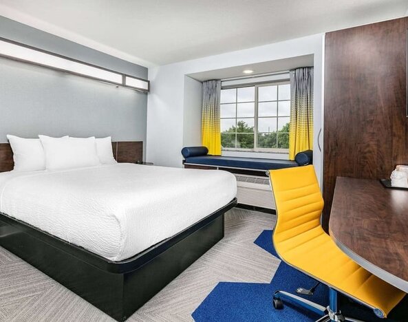 Day use room with TV and work desk at Microtel Inn And Suites By Wyndham Austin Airport.