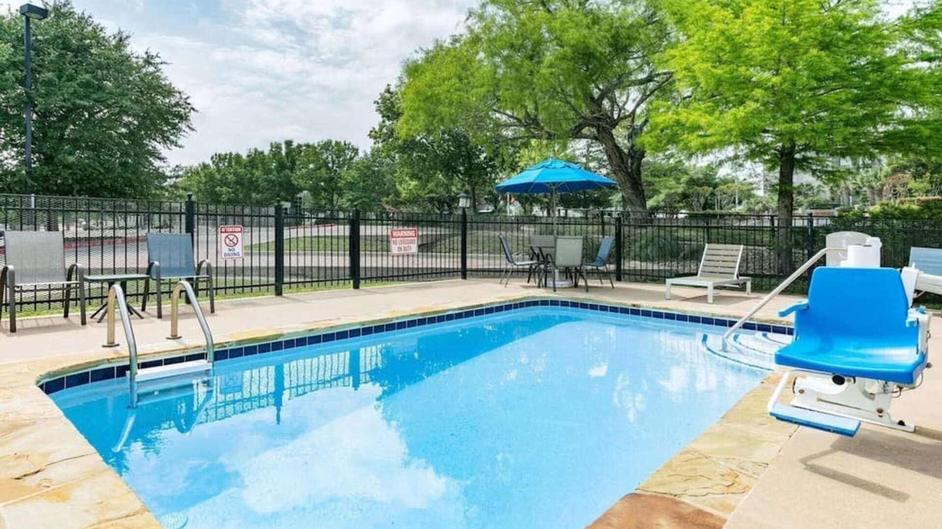 Outdoor pool at Microtel Inn And Suites By Wyndham Austin Airport.
