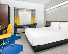 Day use room with TV and work desk at Microtel Inn And Suites By Wyndham Austin Airport.
