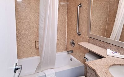 Guest bathroom with shower and tub at Studio 6 Baltimore West - Catonsville.