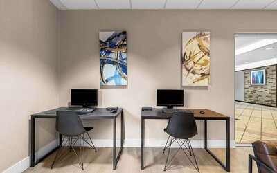 Business center with PC, internet, and printer at Suburban Studios Orlando - Ocoee/Winter Garden.