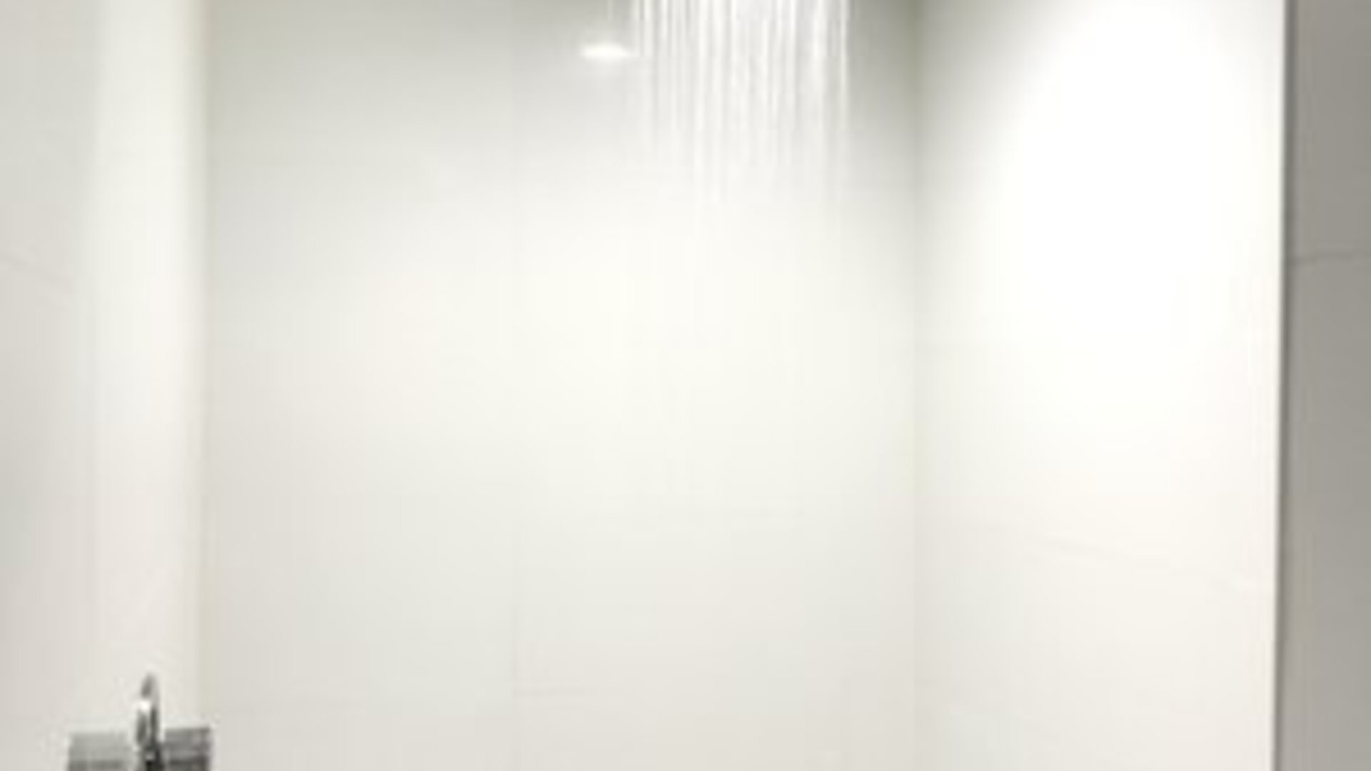 Guest bathroom with shower at Ramsey Inn & Suites.