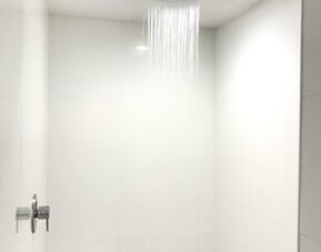 Guest bathroom with shower at Ramsey Inn & Suites.