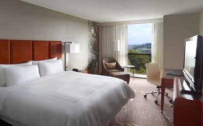 King bedroom with workstation and natural light at Atlanta Marriott Northwest At Galleria.