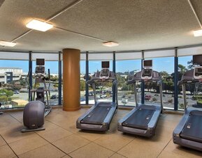 Fitness center with a view at Embassy Suites by Hilton San Francisco Airport.