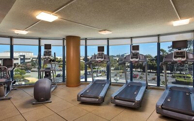 Fitness center with a view at Embassy Suites by Hilton San Francisco Airport.