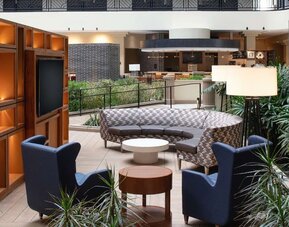 Elegant coworking area in the hotel lobby of the Embassy Suites by Hilton San Francisco Airport.