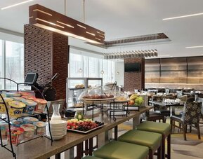 Dining area with natural light perfect for coworking at Hilton Garden Inn Calgary Downtown.