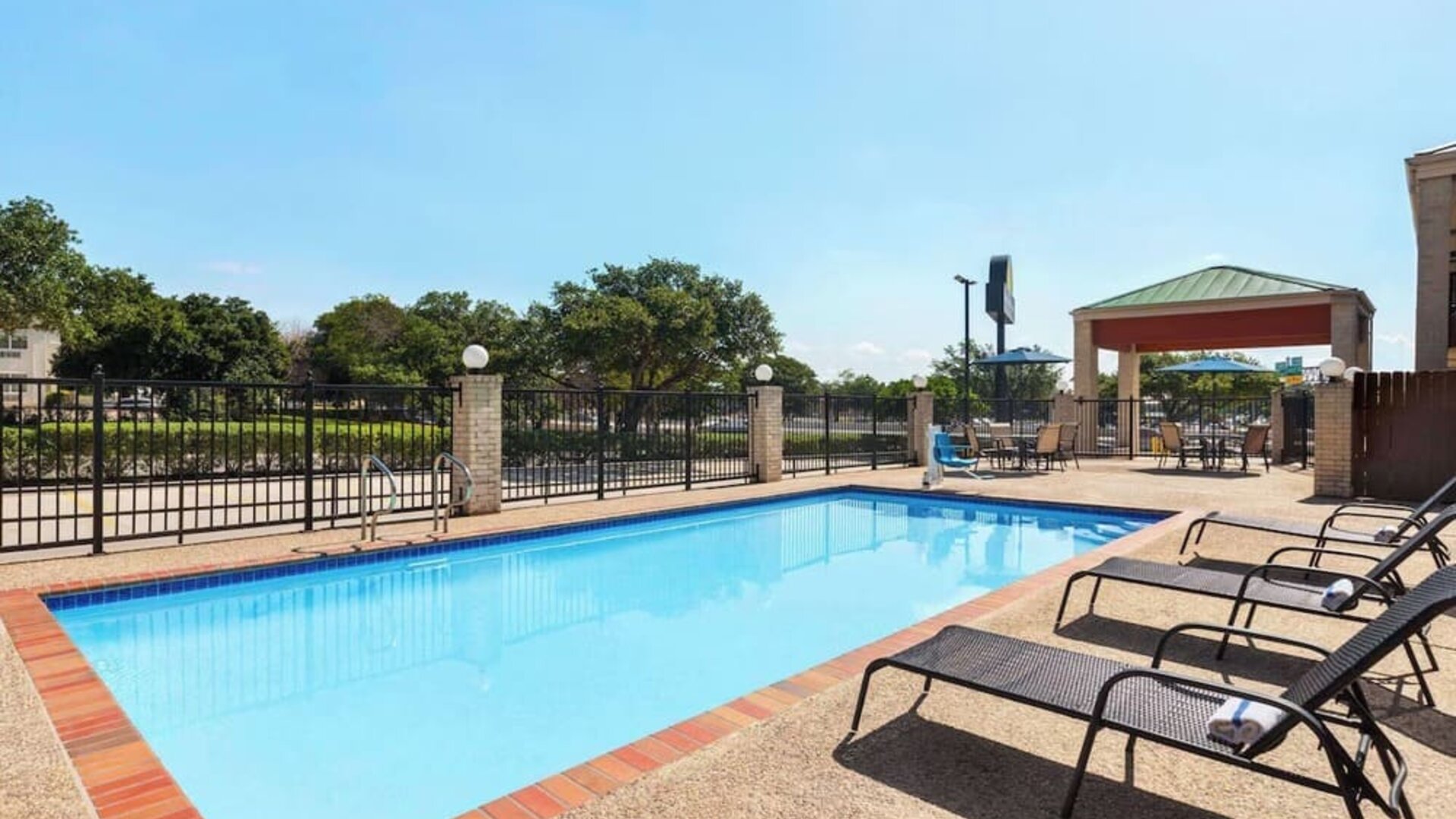 Outdoor pool at Days Inn By Wyndham San Antonio Near Fiesta Park.