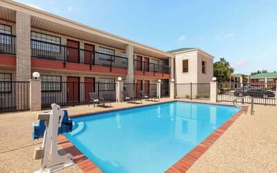 Outdoor pool at Days Inn By Wyndham San Antonio Near Fiesta Park.
