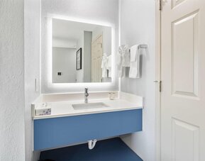 Guest bathroom at AmericInn By Wyndham Urbana.