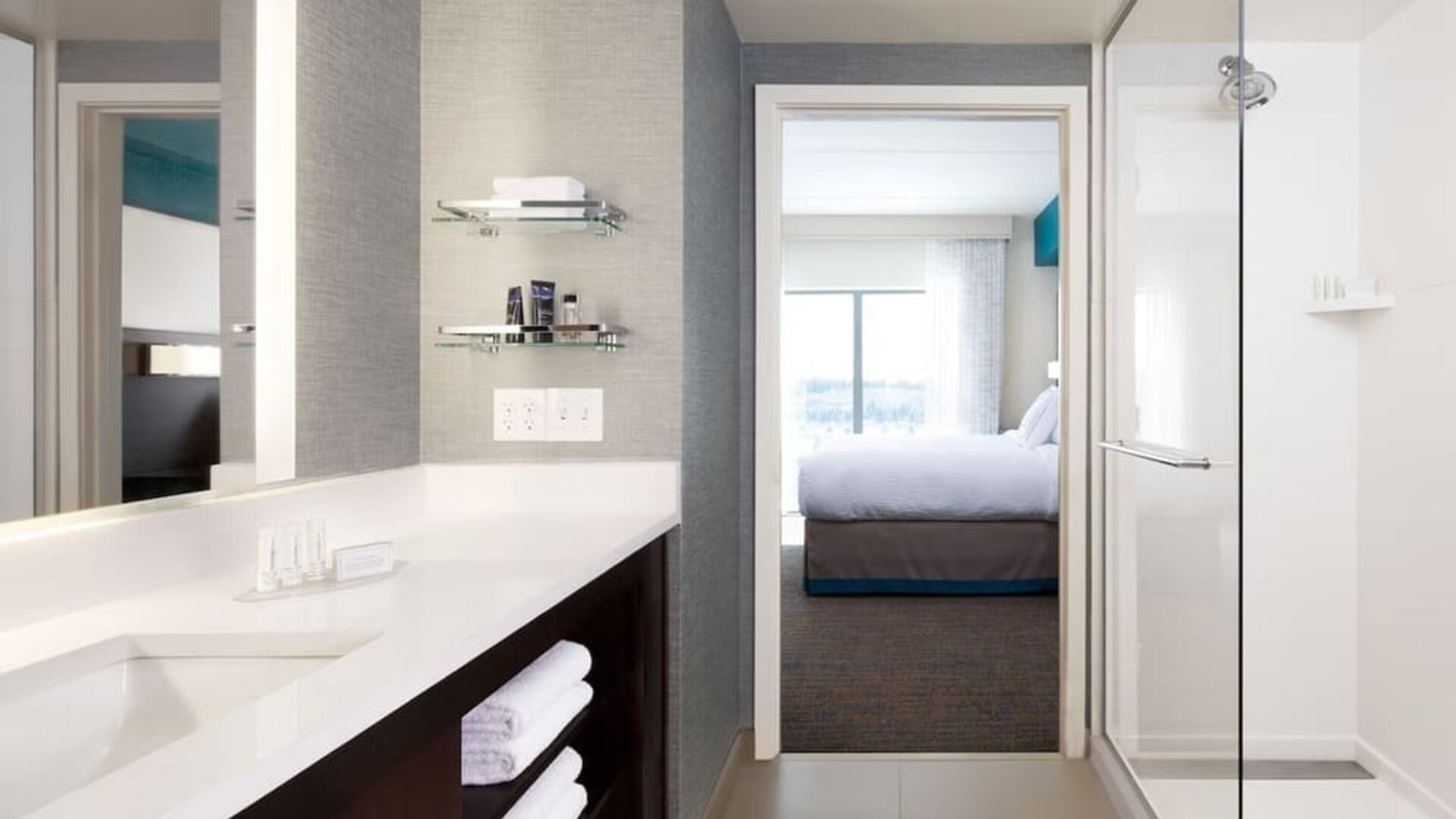 Private guest bathroom with shower and free toiletries at Residence Inn By Marriott LAX Airport.