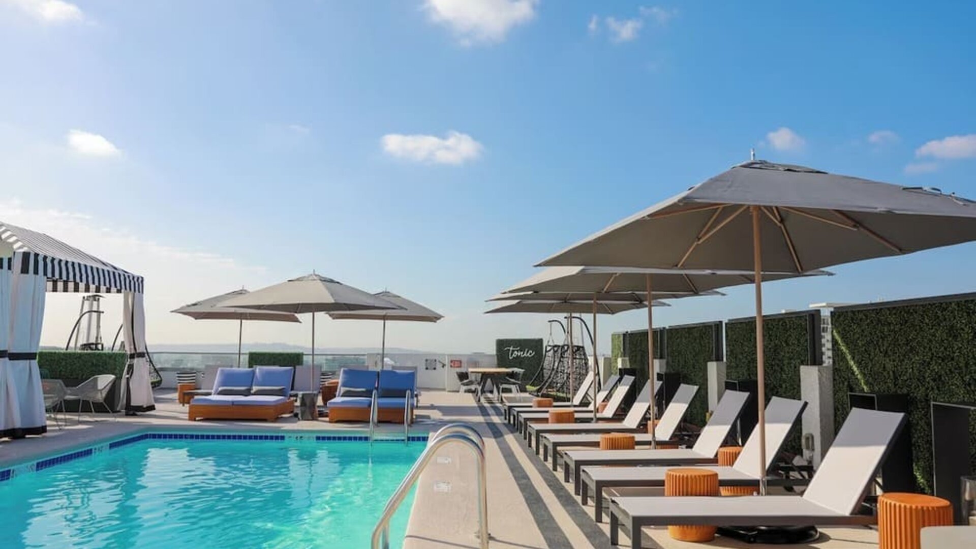 Relaxing outdoor pool with lounge chairs at Montrose At Beverly Hills.