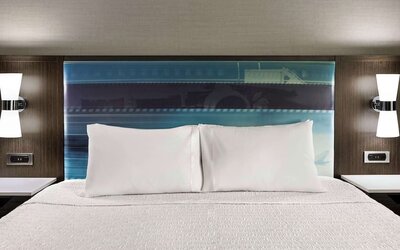 Comfortable king bed at Hampton Inn Chicago-O'Hare International Airport.