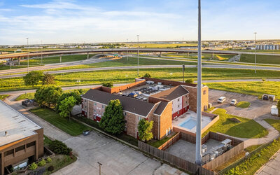Property exterior at Coratel Plus Suites Wichita West Airport.