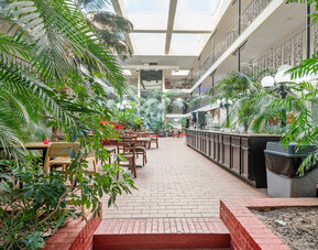 Dining area at Coratel Plus Suites Wichita West Airport.