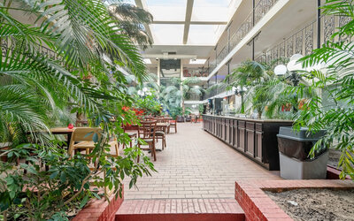 Dining area at Coratel Plus Suites Wichita West Airport.