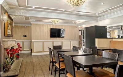 Lobby seating and restaurant at Lemon Tree Hotel & Suites Anaheim.