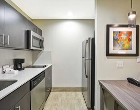 Kitchen at Homewood Suites By Hilton Orlando Theme Parks.