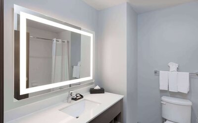 Guest bathroom at Days Inn & Suites By Wyndham Houston NW Cypress.
