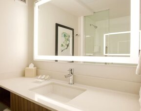 Guest bathroom with shower at Hilton Garden Inn New York Central Park South Mid-town West.