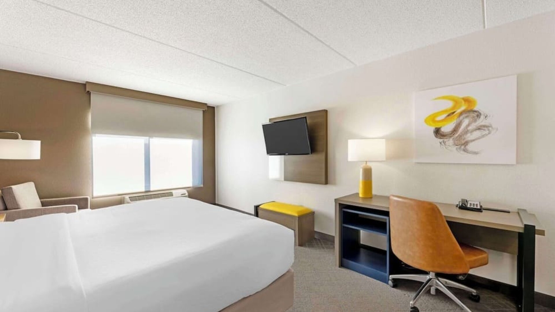 Work desk and TV inside day use room at Comfort Inn & Suites Arlington Heights - Schaumburg.