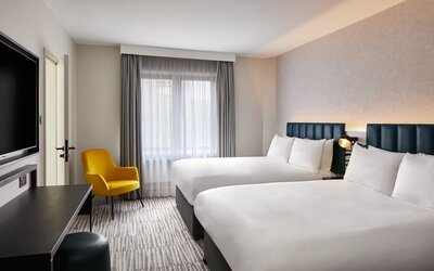 Two queen beds with TV at Leonardo Hotel Dublin Christchurch.