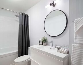 Bathroom at Hilton Garden Inn Tribeca with privacy curtains and plush towels.