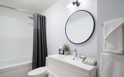 Bathroom at Hilton Garden Inn Tribeca with privacy curtains and plush towels.
