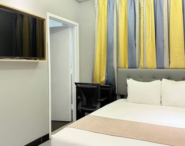 Madison LES Hotel room with double bed, and desk for working.