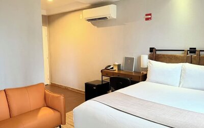 Madison LES Hotel room with double bed, and desk for working.