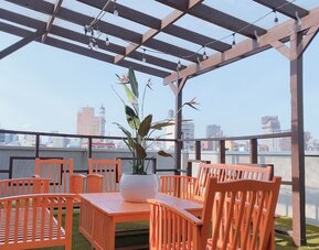 Outdoor terrace with table and chairs for relaxing/socializing.