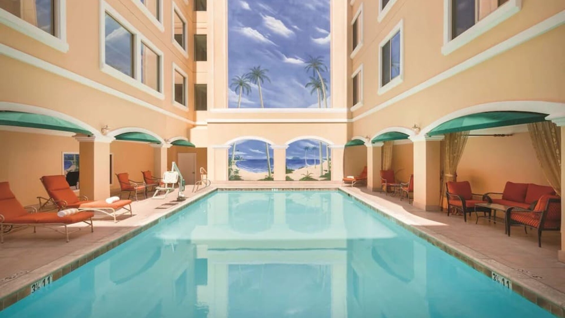 Relaxing large, outdoor pool with loungers at Hilton Los Angeles/San Gabriel.