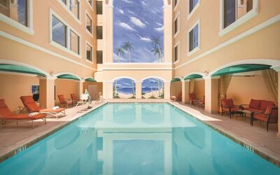 Relaxing large, outdoor pool with loungers at Hilton Los Angeles/San Gabriel.