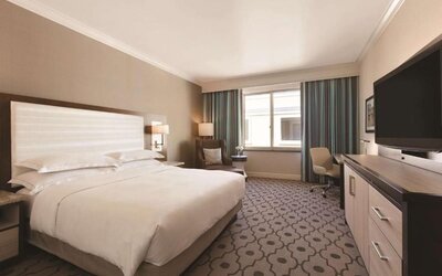 Comfortable day room with desk and chair at Hilton Los Angeles/San Gabriel for a relaxing daycation.