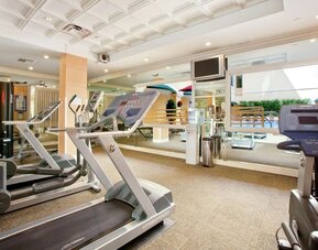Fitness center at Hilton Los Angeles/San Gabriel with a variety of equipment for a full workout.